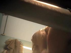 Busty girl gets dressed in the cabin