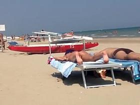 Round ass woman in orange bikini