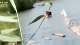 The pair having sex in the water in the pond.