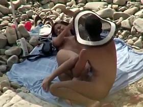 Guy with a funny hat fingers his girl