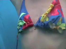 Tan lined chick uncovering her body in beach cabin