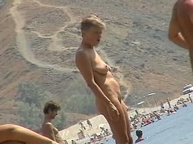 Sexy teeny babes topless on a beach get filmed by a voyeur camera