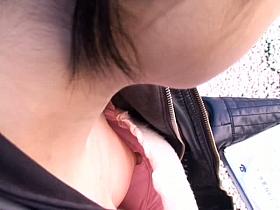 Sexy babe without a brassiere in the middle of the street