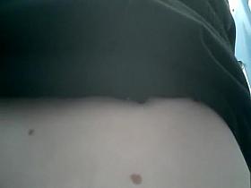 Brunette peeing in portable toilet