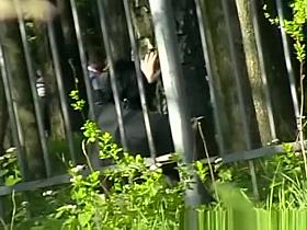 Woman pissing in public park