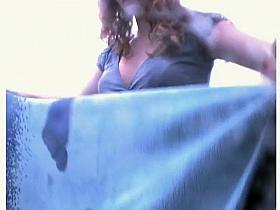 Mature lady showers in a beach cabin