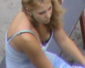 A dude is filming the nice cleavage of a hot babe