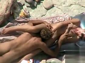 Going down on his girlfriend at the beach