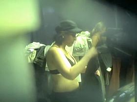 Spy cam chick in cap without the top in dressing room