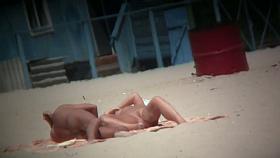 Couple exposing for the hidden cams at the beach