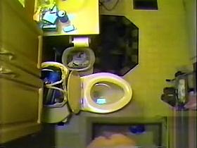 Ceiling cam films her naked in the bathroom