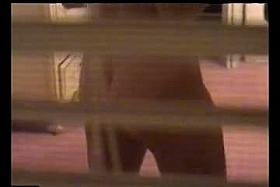 An alluring woman getting dressed in front of a window