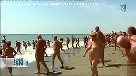 Mature Spanish nudists walk around the beach completely naked