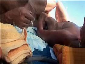 Hairy husband gets a handjob from his wife in public