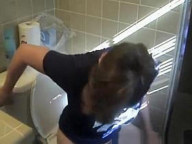 Busty woman in bathroom toilet peeing