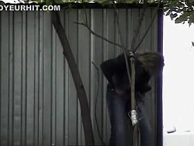 Blonde woman in sunglasses squats to pee