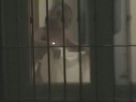 Blonde lady with naked natural boobs in the voyeur thru window clip