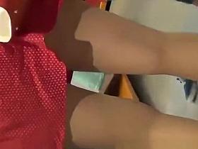 Woman in red skirt wearing stockings upskirted