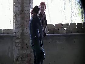 Well dressed women pee in a old building