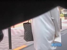 Beautiful babe with a white coat on skirt sharked in public