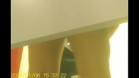 Brunette in bra is trying to zip the tight jeans