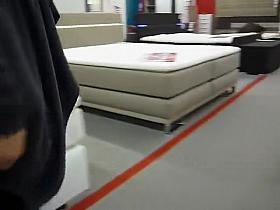 Pervy woman exposes her puffy pussy at the furniture store