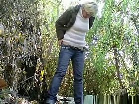 Mature pissing and smoking outdoors