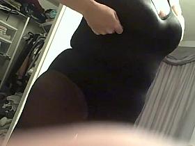 bbw putting on her Black body stocking.
