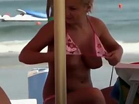 Blonde lady about to cover her boobs