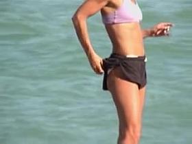 Sporty girl in sexy bra and candid shorts on the beach 01m