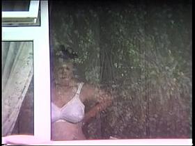 mature neighbor putting on bra