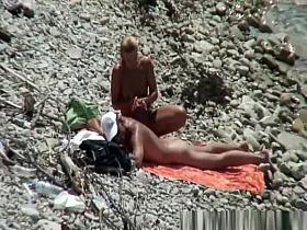 Blonde nudist woman enters the water