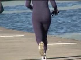 Candid ass milf is running along the golden beach 08i