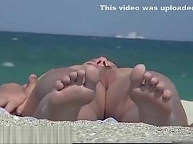 Nudist couples video clip by a hidden beach camera