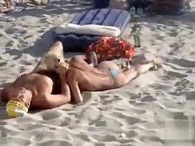 Doing the fellatio on a crowded beach