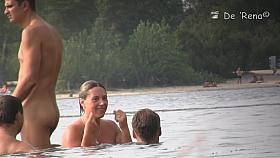 Sun warming up bodies of beach nudist girls and men