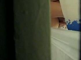 Shower voyeur clip of a chubby girl washing her hairy pussy