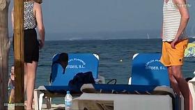 Girl on the beach dresses pants.