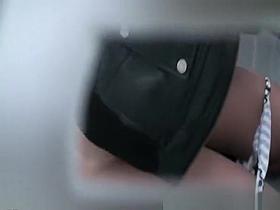 Woman peeing in portable public toilet