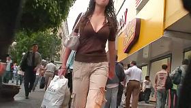 Curly chick with beautiful boobs is being a star in street candid