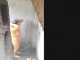 Woman filmed in secret while bathing in a outdoor scene